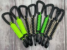 several pairs of black and green zippers on wooden background