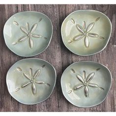 four plates with dragonflies on them sitting on a table