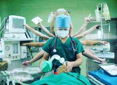 doctors in scrubs and surgical masks are performing surgery