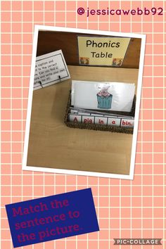 a table with an open book and a cupcake on it that says phonics table match the sentence to the picture