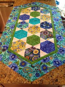 a quilted table runner on top of a kitchen counter