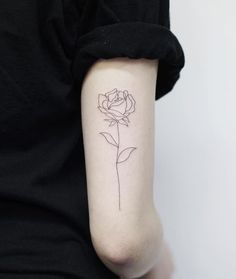 a single rose tattoo on the arm