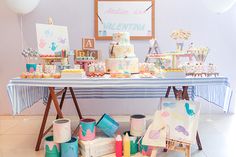 a table filled with lots of different types of cakes and cupcakes on top of it