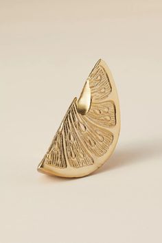 a close up of a gold ring on a white background