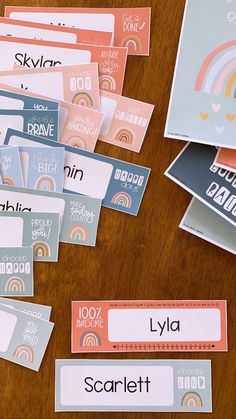 several different name tags on a table with one being an envelope and the other has a rainbow