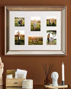 a family photo hanging on the wall in front of a table with candles and other items