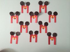 a group of people made out of paper with mickey mouse cut outs on the side