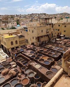 many pots are stacked on top of each other in the middle of an old city