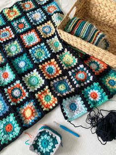 a crochet granny blanket and some yarn next to it