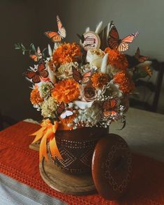 a vase filled with lots of flowers on top of a table