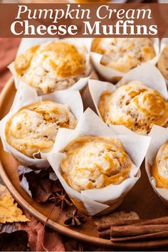 pumpkin cream cheese muffins on a plate with cinnamon sticks and an orange napkin