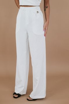 Introducing the Classy Pin Stripe Set in White, a sophisticated and timeless set that exudes elegance and style. The perfect choice for both professional settings and formal occasions. Whether worn together for a coordinated look or styled separately for versatility, this set is sure to elevate your spring wardrobe with its understated sophistication and modern flair. Pinstripe set Top: Lightweight, cropped, zip closure, thick strap, lined Bottoms: Functional pockets, Zip + Clasp closure, nonfun Elegant White Sets For Business, Elegant White Business Sets, Chic Tailored White Sets, Tailored Timeless Sets For Workwear, Chic White Business Sets, Classic White Sets For Office, Elegant Sets For Workwear, Classic White Office Sets, Spring Formal Office Lady Sets