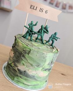 there is a cake with green frosting and soldiers on top that says hell is 6