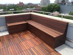 a wooden bench sitting on top of a roof