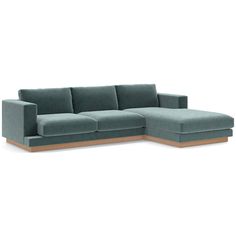 a blue sectional couch sitting on top of a white floor next to a wooden frame