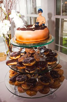 two tiered trays filled with donuts and doughnut holes on top of each other