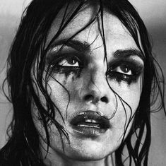 a black and white photo of a woman with makeup