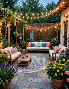 an outdoor living area with patio furniture and string lights