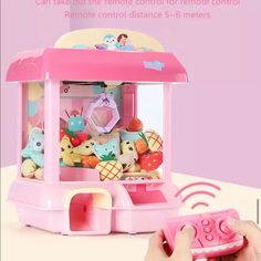 a pink toy machine with stuffed animals in it