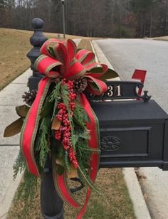 a mailbox decorated with red and green ribbon