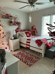 a bedroom decorated for christmas with red and white decor