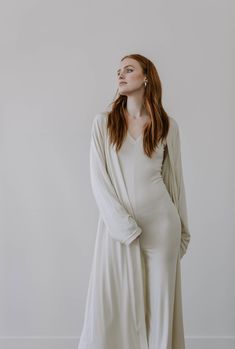 "This luxe, full length lightweight cardigan is made from a finely ribbed fabric with a super soft hand feel. It has a relaxed fit, drop shoulders and slouchy sleeves for a slightly oversized look. Made from 90% plant based, environmentally responsible TENCEL, it's light as air while providing the perfect amount of coverage. The 10% Spandex fabrication also adds a bounce and stretch for exceptional comfort. Like all of our pieces, this cardigan is exclusively handmade to order by us in limited q Wide Legged Jumpsuit, Cozy Jumper, Elegant Pants Suits, Jumpsuit And Cardigan, Long Oversized Cardigan, Cream Colored Cardigan, Luxe Loungewear, Spring Cardigans, Luxury Loungewear