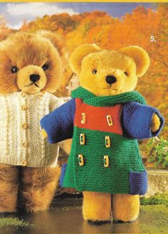 two teddy bears dressed up in sweaters and boots standing next to each other with autumn foliage behind them