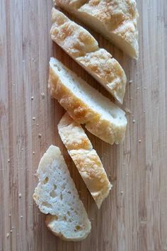 sliced bread sitting on top of a wooden cutting board