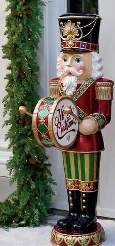 a christmas nutcracker is standing in front of a door