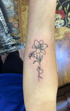 a black and white flower tattoo on the arm