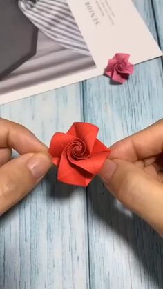 someone is making a flower out of paper