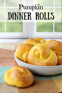 pumpkin dinner rolls in a bowl on a table