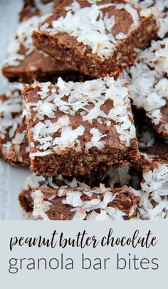 some brownies are stacked on top of each other with coconut flakes all over them