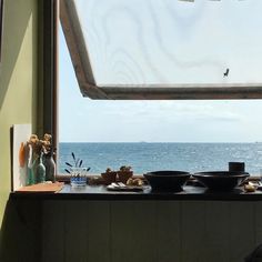 there is a window that looks out to the ocean