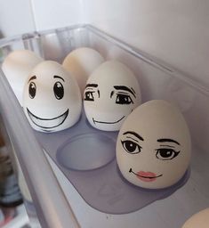 three eggs with faces drawn on them in a refrigerator