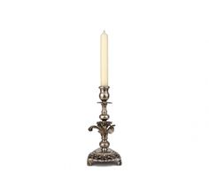 a silver candle holder with a single lit candle on the top and an ornate base