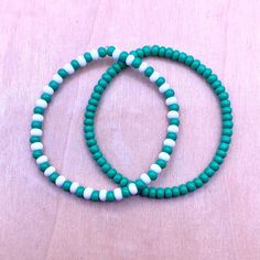 Ullabeads Green and White Bead Bracelet | Green Bead Bracelet Stack | Green Bead Anklet ⚠️NOTE: Please do NOT guess wrist size! Always measure your wrist :) ❤️ 🟢⚪️🟢⚪️🟢⚪️🟢⚪️ The color green is associated with luck peace, wealth, harmony, growth and nature. These stretchy green bracelets are great for any occasion and make a bold statement! Pair this set with your favorite outfit or footwear. Add these bracelets to your collection today! 🍀 📌OPTIONS A) Green Bracelet ONLY B) Green and White Bracelet ONLY C) Set of both  📌 Details: * 4mm Seed Beads * Elastic Stretch Cord ⬇️ WANT MORE SEED BEADS? STACK 'EM ⬇️ ✨ Ullabeads Red Bead Bracelet Set ✨ https://ullabeads.etsy.com/listing/1486854044  IMPORTANT -- PLEASE READ  ⭐️ NOTE: Ullabeads jewelry pictures are enlarged to show detail. These s Green Friendship Bracelet, White Bead Bracelet, Bead Bracelet Stack, White Beads Bracelet, Bead Anklet, Red Beaded Bracelet, Green Beaded Bracelets, Green Bracelet, White Bracelet