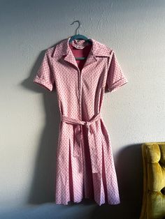 Vintage 1970s dress from the brand Country Miss. Light pink base with geometric polka dots all over. Very cute with a matching belt, pleated drop waist, and a front zipper closure. Tony snag on the front. Please refer to measurements for desired fit. Bust: 34" Waist: 32" Drop waist: 38" Total length: 42" Retro Pink Collared Dress, Retro Pink Dress For Work, Pink Retro Dress For Work, 70s Country, 1970s Dress, Country Vintage, Lubbock Tx, Seventies Fashion, 1970s Dresses