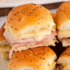 ham and cheese sliders stacked on top of each other with black pepper sprinkles