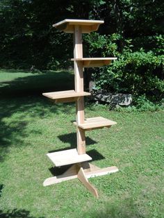 a tall wooden shelf sitting on top of a lush green field