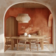 a dining room with an archway leading to the kitchen and living area, along with a wooden table surrounded by chairs