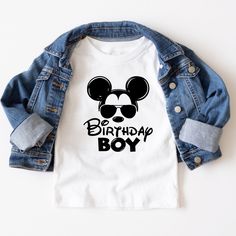 a mickey mouse shirt with the words be birthday boy printed on it, next to a jean jacket