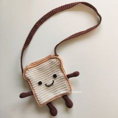 a crocheted piece of bread with a smiling face on it's side