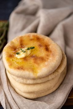 there are three breads on top of each other with cheese and herbs in the middle