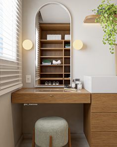 a wooden desk topped with a mirror next to a shelf filled with books and other items