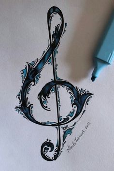 a pen and ink drawing of a treble clef on paper with watercolor pencils