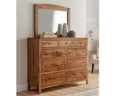 a wooden dresser with a mirror on top of it