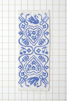 a blue and white towel hanging on a tiled wall