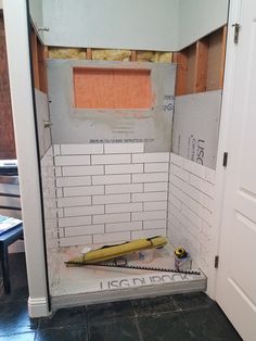 the bathroom is being remodeled and ready to be used as a mud room for construction