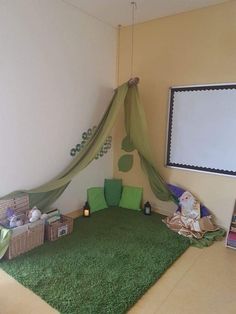 a room that has a green rug on the floor and a bed with a canopy over it